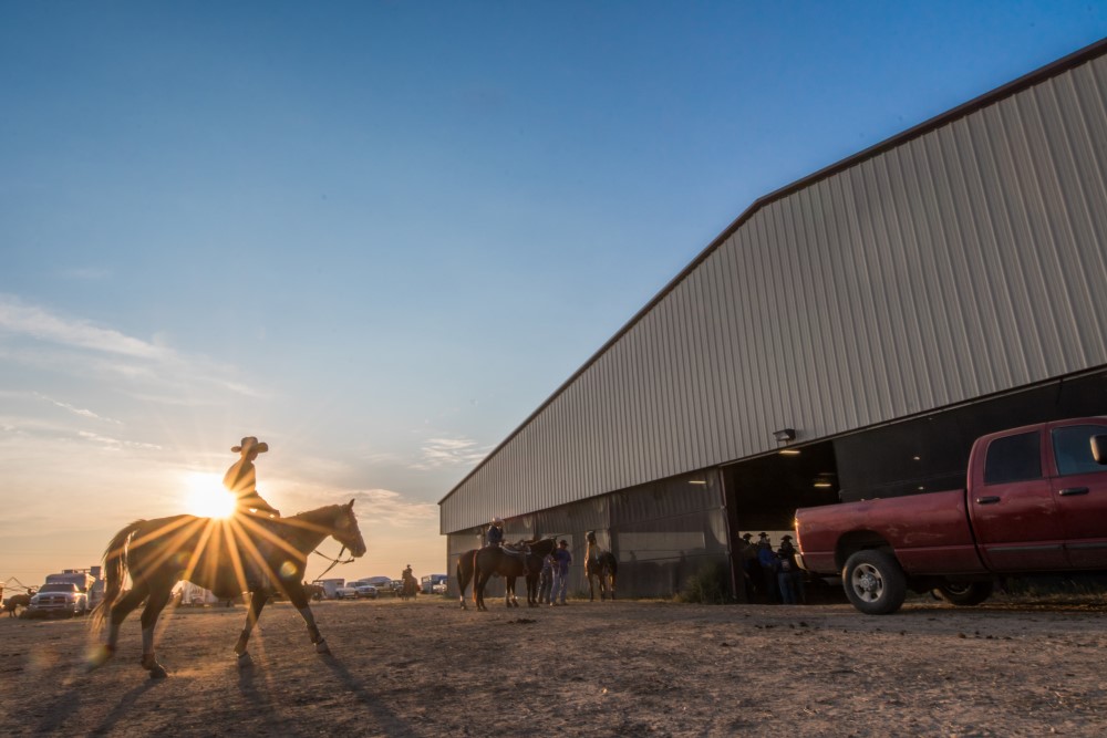 A competitor on horseback walks into Mustang Pavilion in Kim, Colorado, for the Little Britches Rodeo. Photo by Moxie82 Inc.