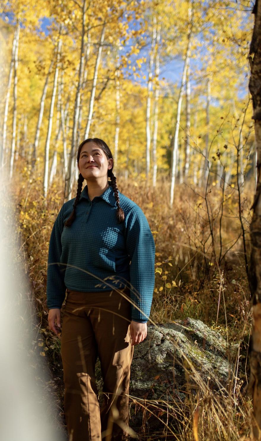 Kylie Yang walking amongst golden aspen groves