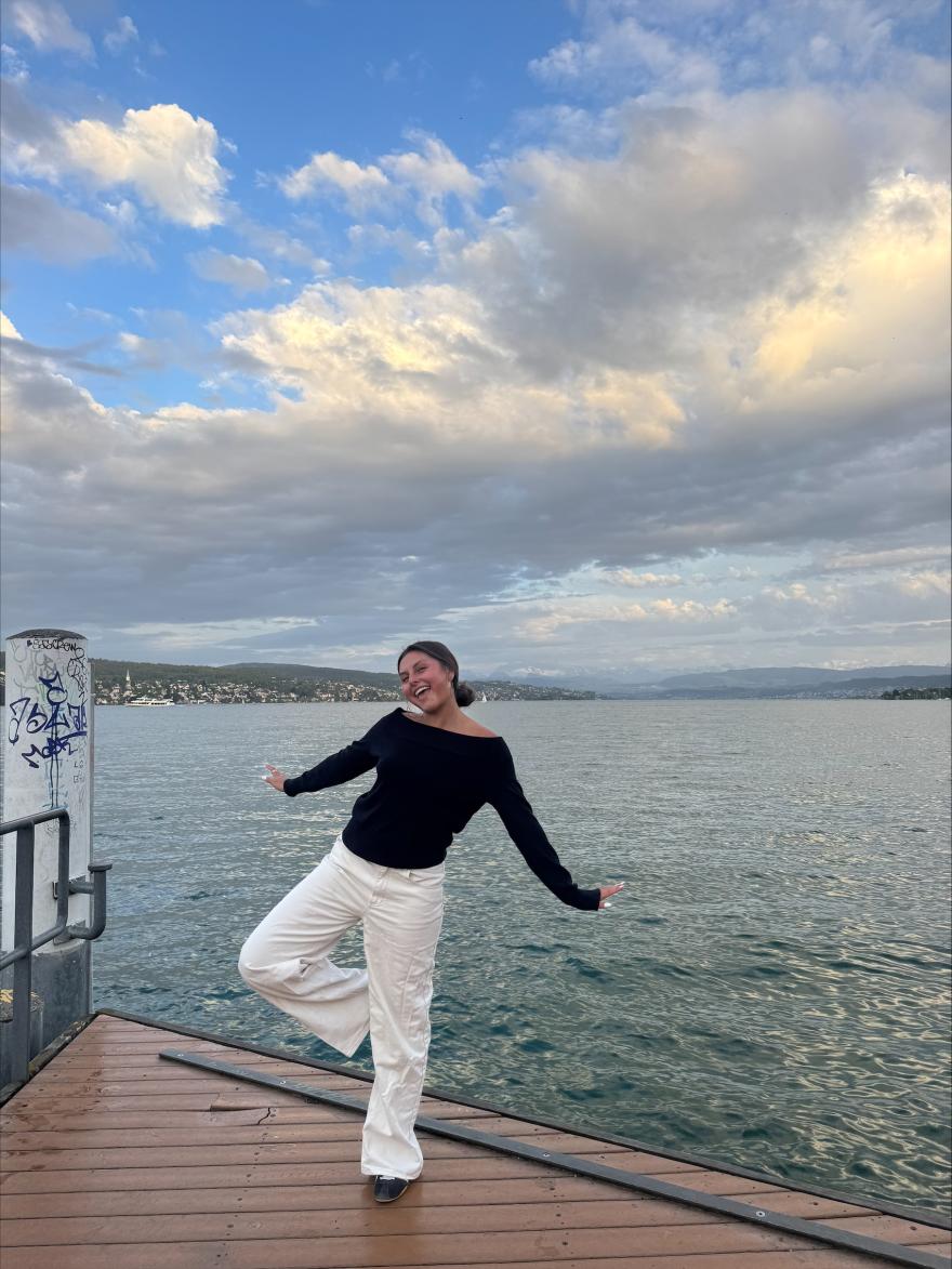 Sofia Blanco posing for a photo on a dock in front of a body of water. 